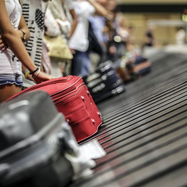 Suitcase on luggage conveyor belt in the baggage claim at airport